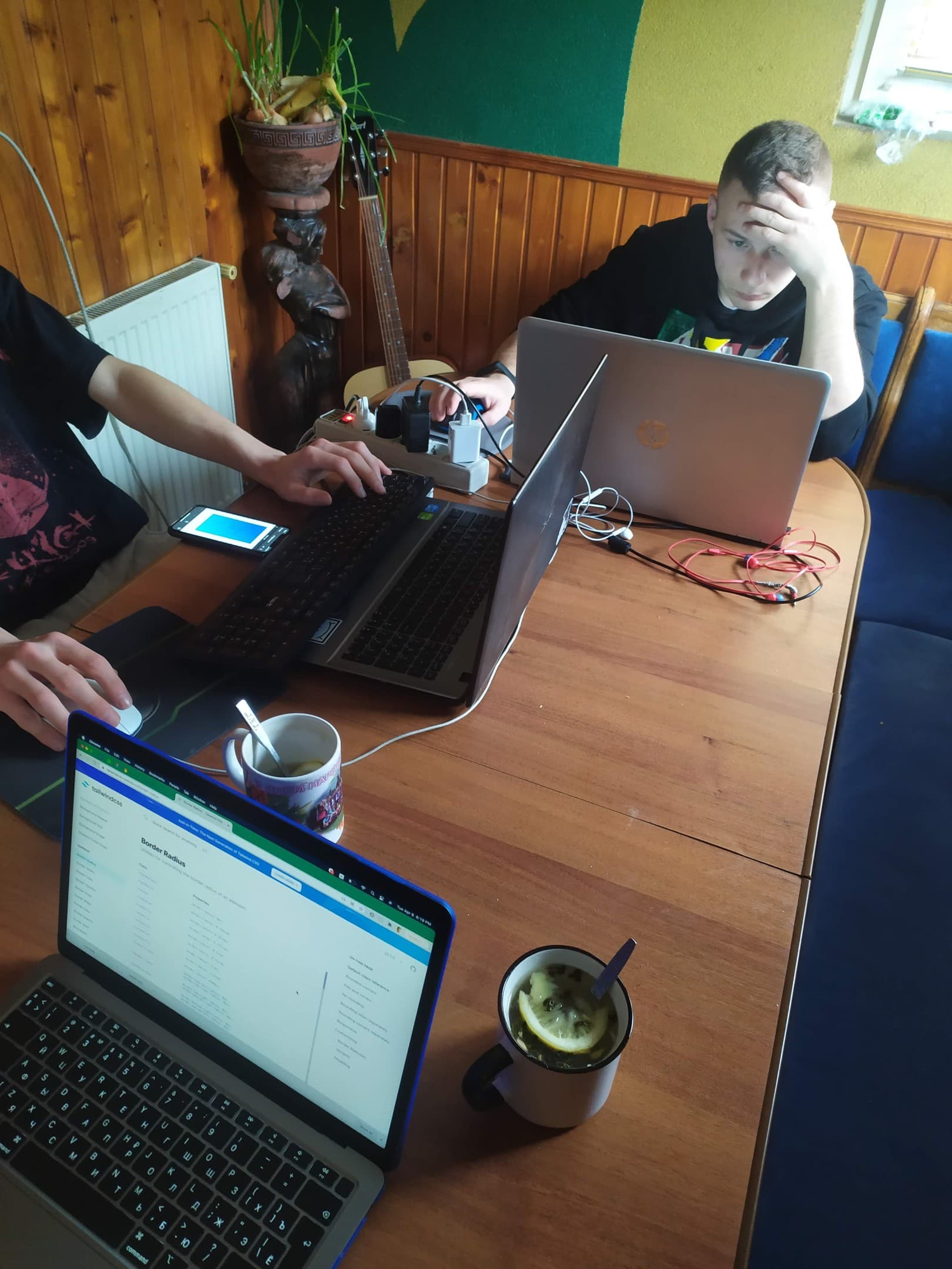 Working late on laptops at a kitchen table.