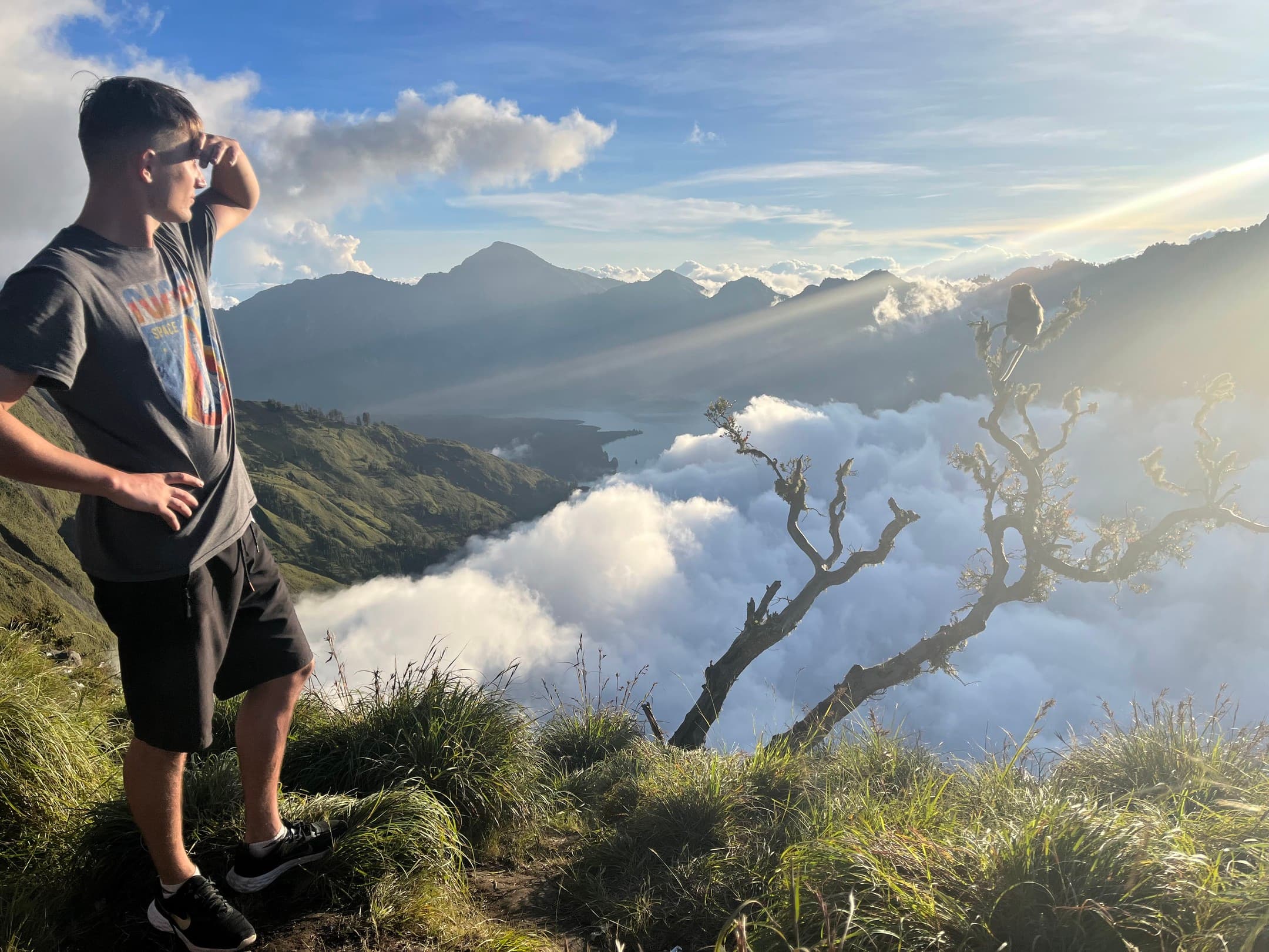 Standing on a ridge above a sea of clouds.